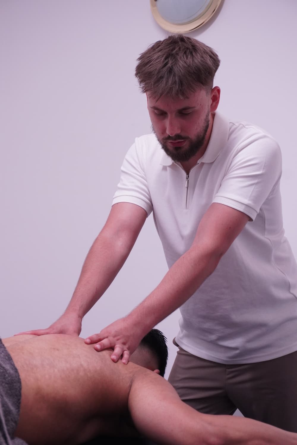 Daniel Marzec sports massage therapist performing treatment at Muscle Relief Therapy Swansea