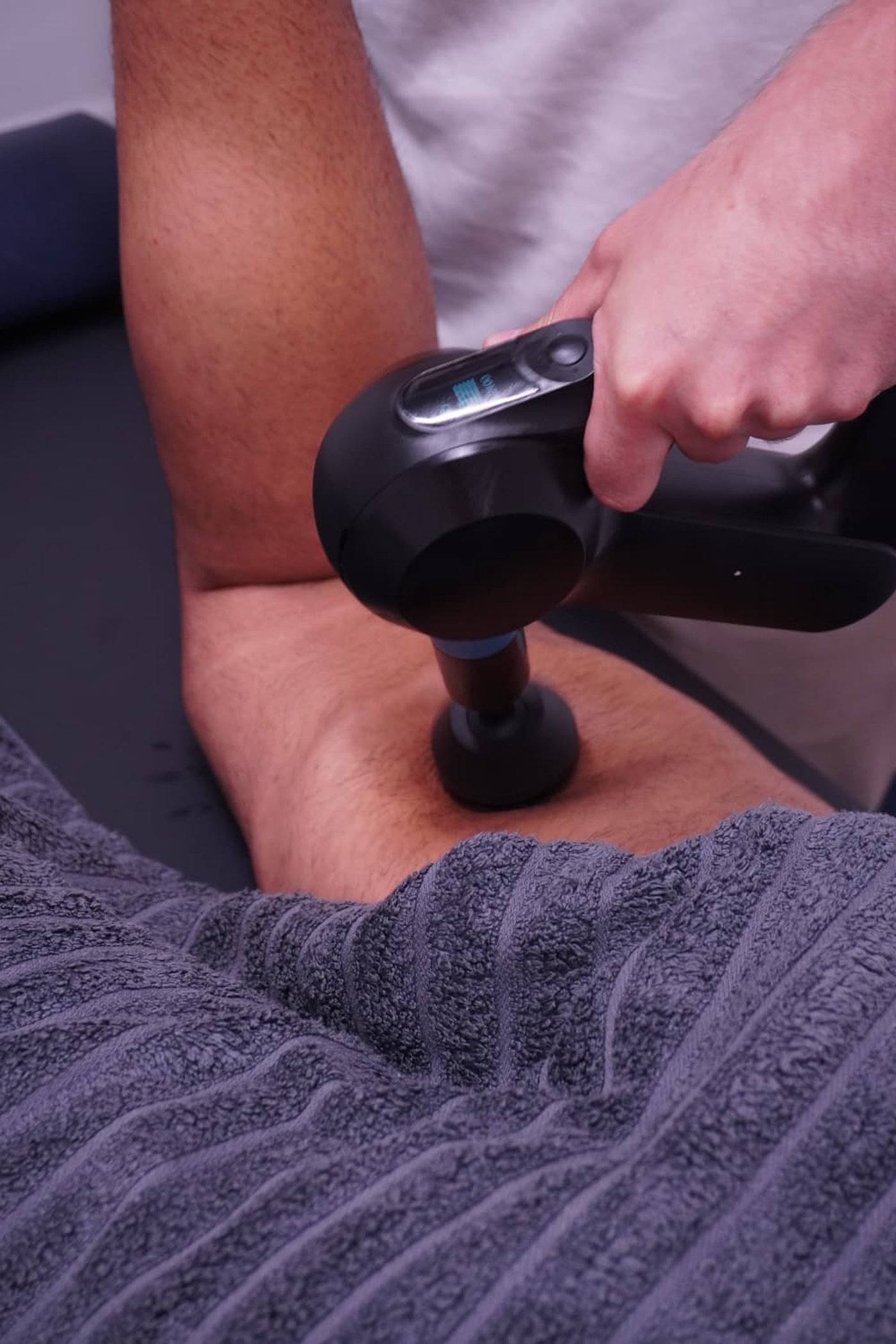 Deep tissue sports massage with massage gun therapy at Muscle Relief Therapy Swansea
