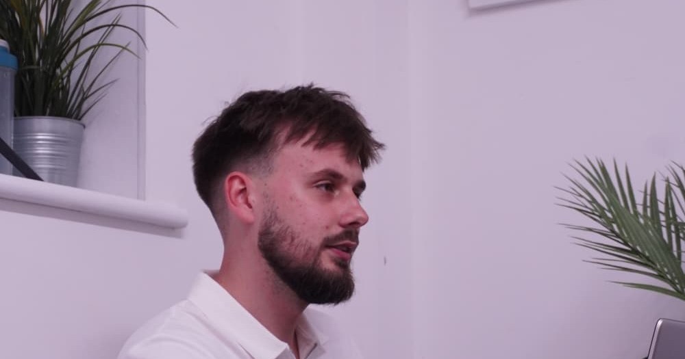 Daniel Marzec at desk during initial sports massage consultation at Muscle Relief Therapy Swansea — Muscle Relief Therapy, Swansea